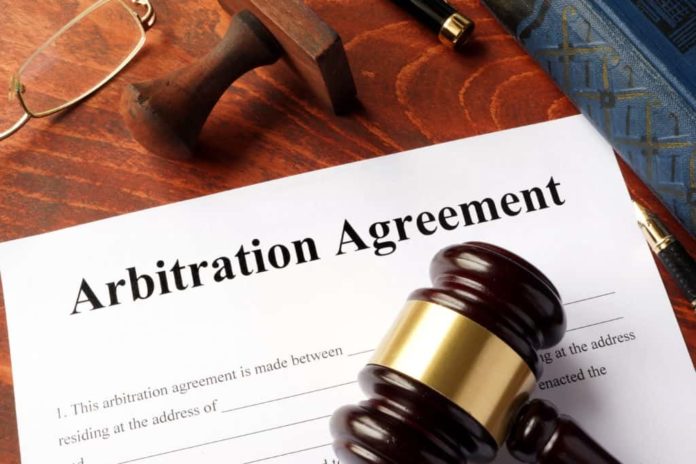 An arbitration agreement sitting under a gavel.