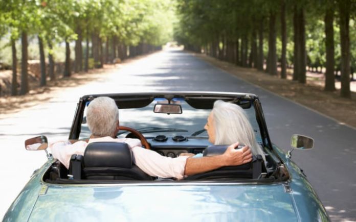 Elderly couple taking a drive out on a road.