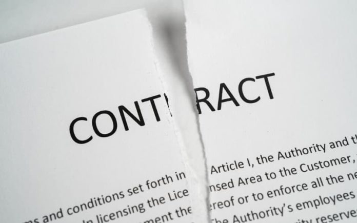 A contract being ripped in half.