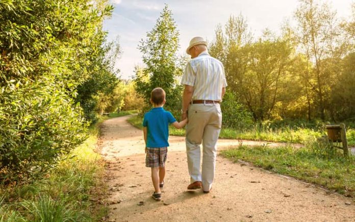A grandparent walking with their grandson - Hammerle Finley Law Firm