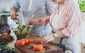 elderly couple preparing food