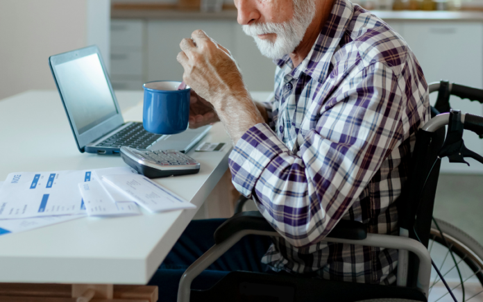 elderly man sitting in front of a computer