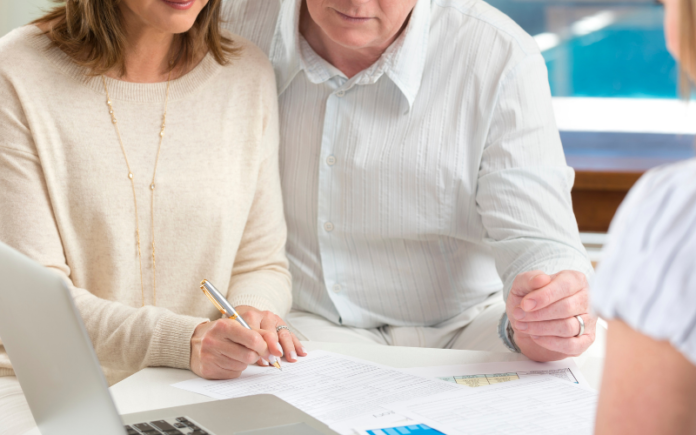 man and woman sitting at a table looking at paperwork