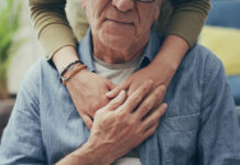 Comforting hand on shoulder of man