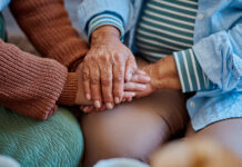 woman holding hands with her elderly relative