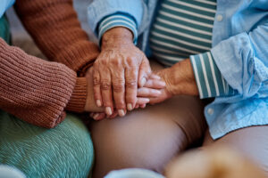 woman holding hands with her elderly relative