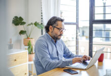 man using laptop at home