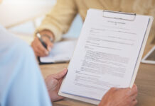 Person holding last will and testament with safety and security in retirement or death.