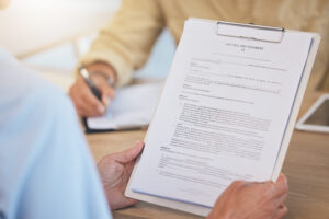 Person holding last will and testament with safety and security in retirement or death.