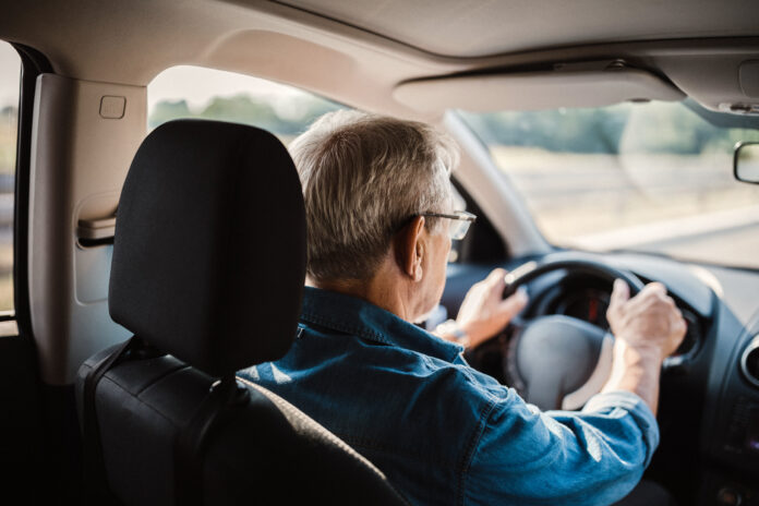 Senior man driving car on the highway