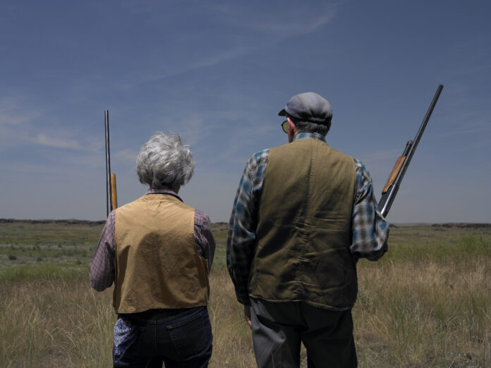 Elderly man and woman with shotguns