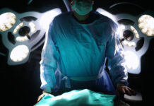 Surgeon in front of surgery desk, dark side