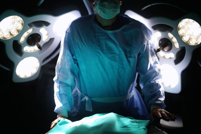 Surgeon in front of surgery desk, dark side