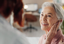 Doctor, senior woman and hearing aid in clinic for geriatric support, tinnitus and help for sound waves. Ent, otolaryngology and patient with cochlear implant for audio, healthcare and auditory tech