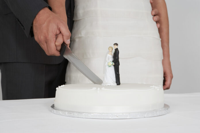 Newlyweds cutting the wedding cake