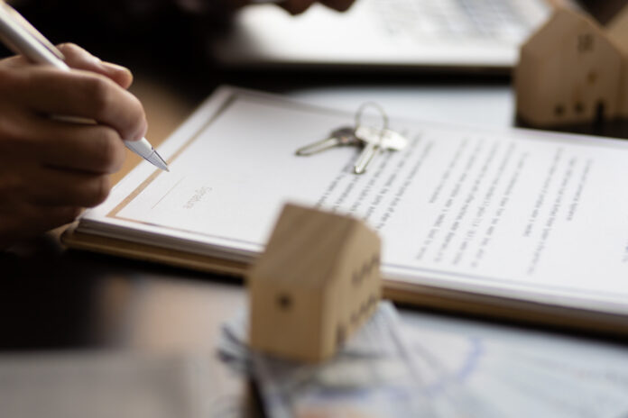 Businessman signing a contract for a purchase agreement mortgage and rental housing.